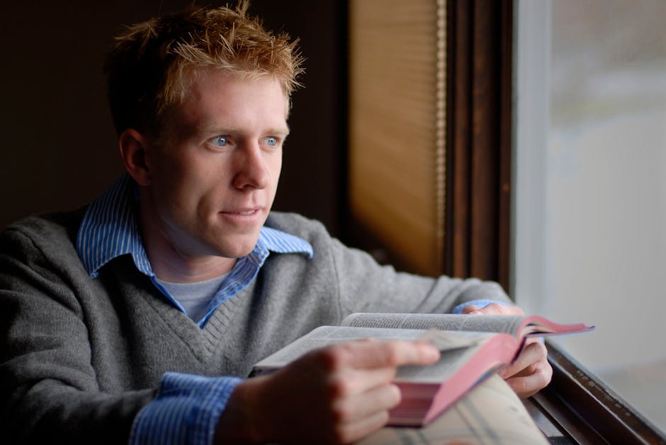 A person finding a moment of calm meditation by a large window