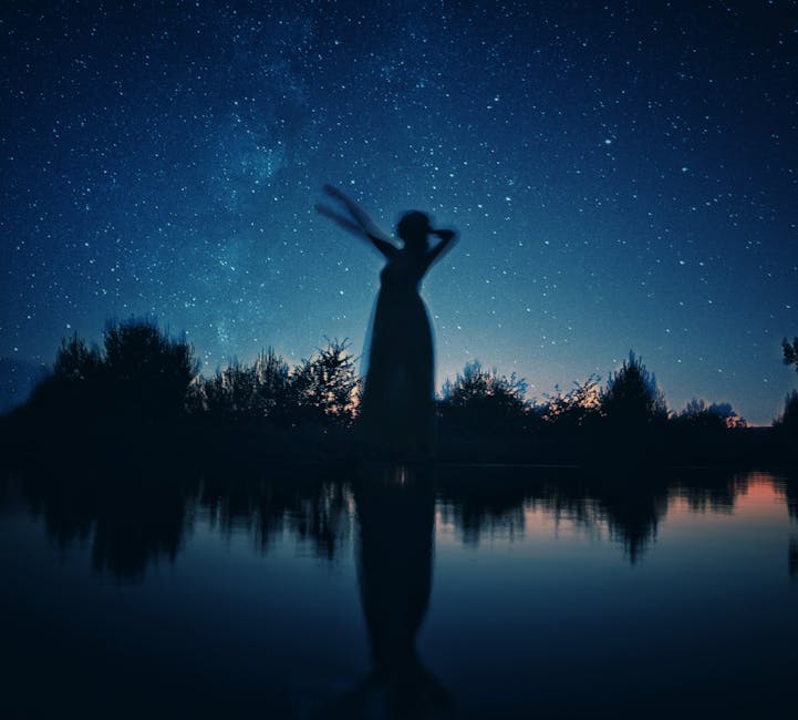 Calm person meditating outdoors near still water reflecting the sky