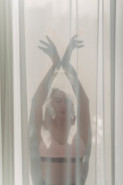 Woman performing a gentle yoga pose in a beautifully lit, calm living room